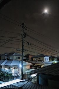 Illuminated road against sky at night