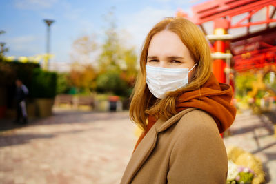 Portrait of a beautiful young woman standing outdoors