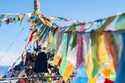 Low angle view of flags hanging against sky