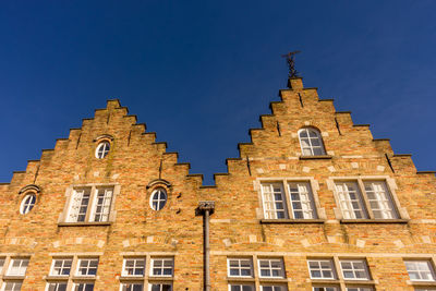 Low angle view of building against clear blue sky