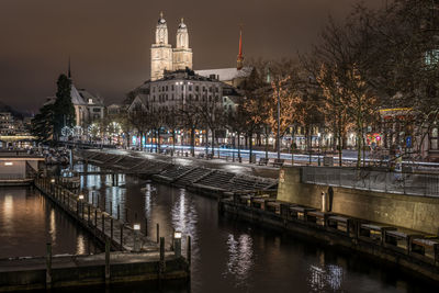 View of illuminated bridge over river at night