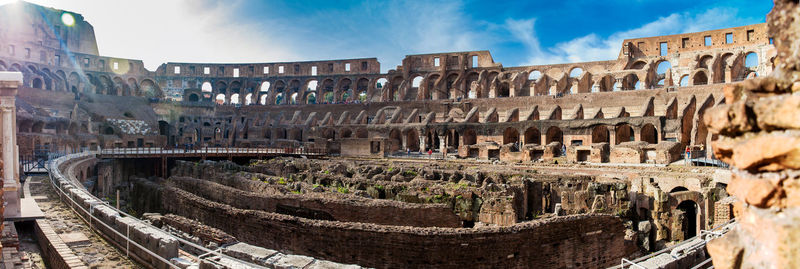 Panorama of the interior of the roman colosseum showing the arena and the hypogeum in a sunny day