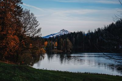 Scenic view of lake by trees against sky during autumn