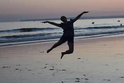 Full length of man jumping on beach