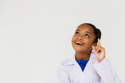 Portrait of a smiling young woman over white background