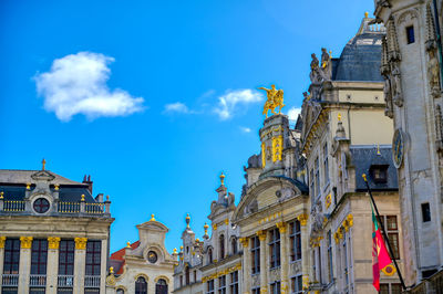 Low angle view of buildings against blue sky