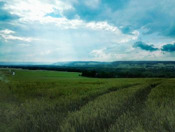 Scenic view of landscape against cloudy sky