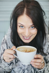 Young woman with cup of coffee