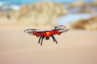 Drone with mounted camera flying over the beach