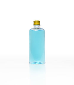 Close-up of glass bottle against white background