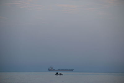 Boat sailing in sea against sky