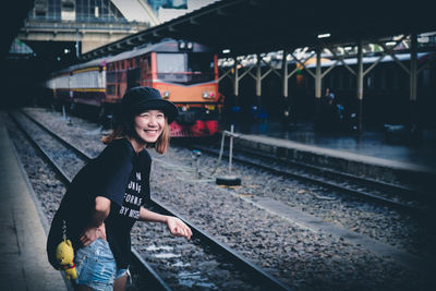 Portrait of smiling woman at railroad station