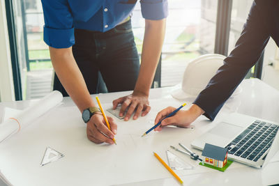 Low angle view of people working on table