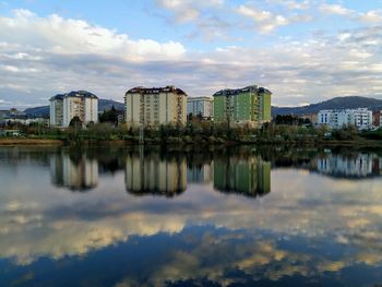 Reflection of buildings in lake against sky