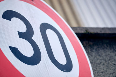 Close-up of speed limit sign on road