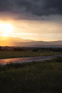 Scenic view of field against sky during sunset