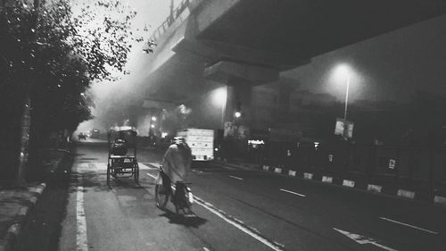 Rear view of a woman walking on road