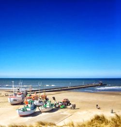 Scenic view of beach against blue sky