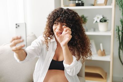 Young woman using mobile phone at home