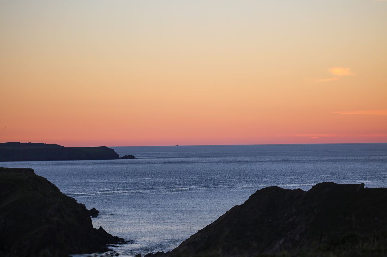 sky, sea, scenics - nature, water, sunset, beauty in nature, tranquility, tranquil scene, horizon over water, orange color, horizon, beach, idyllic, land, rock, nature, non-urban scene, no people, rock - object, outdoors