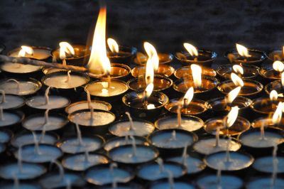 Lit candles burning in temple