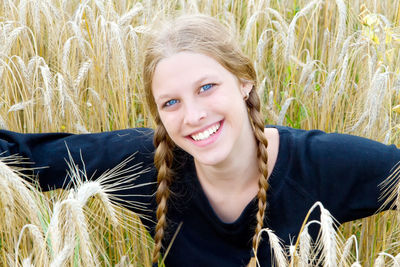 Portrait of smiling young woman in field