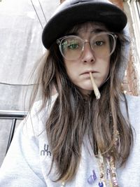 Portrait of woman holding marijuana joint in mouth