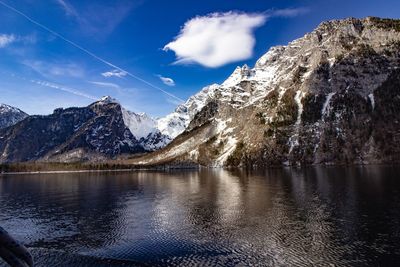 Scenic view of lake and snowcapped mountains against sky