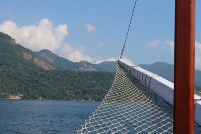 Scenic view of sea and mountains against sky