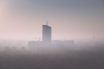 Buildings in city against sky during sunset