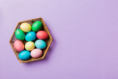 Directly above shot of eggs in carton on blue background