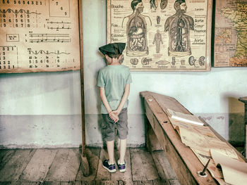 Man standing against wall