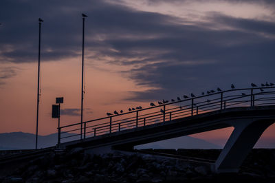 Silhouette bridge against sky during sunset