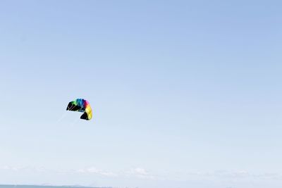 Low angle view of paragliding against clear sky