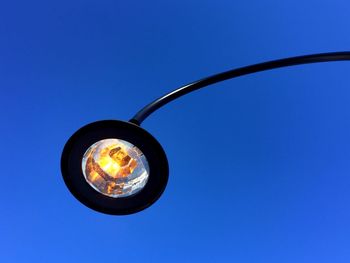 Low angle view of street light against clear blue sky at dusk