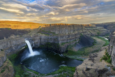 Scenic view of waterfall against sky