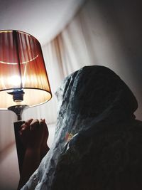 Close-up of hand holding illuminated lamp