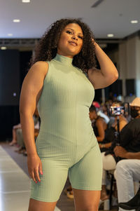 Portrait of young woman standing in corridor