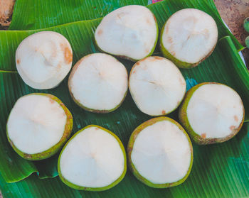 High angle view of fruits and leaves on table