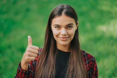 Portrait of smiling woman standing outdoors