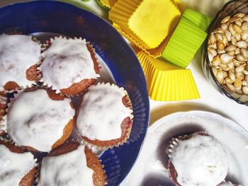 High angle view of cream on cupcakes in plate on table