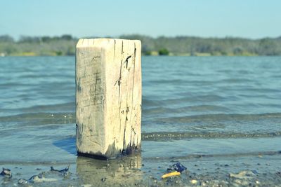 View of wooden post in water