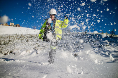 Photography of young woman having fun with snow