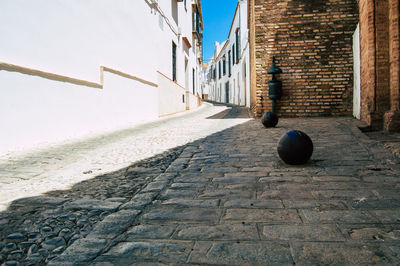 Footpath amidst buildings against sky