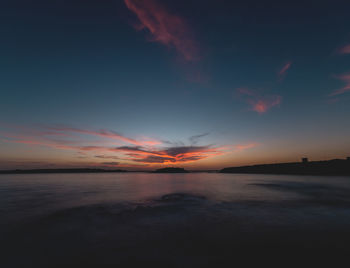 Scenic view of sea against romantic sky at sunset