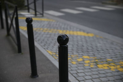 Street light on road by railing in city