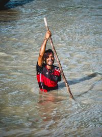 High angle view of smiling man in river