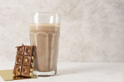 Delicious homemade cocoa drink with cocoa powder and pieces of chocolate bar. copy space.