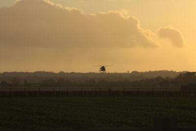 Helicopter over landscape against the sky