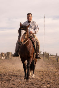 Portrait of man riding horse